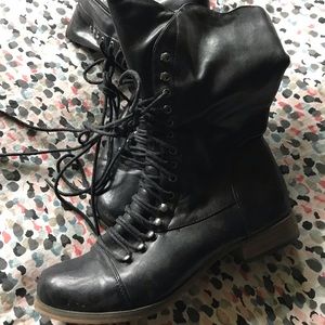 Black ankle lace up boots in a faux leather.